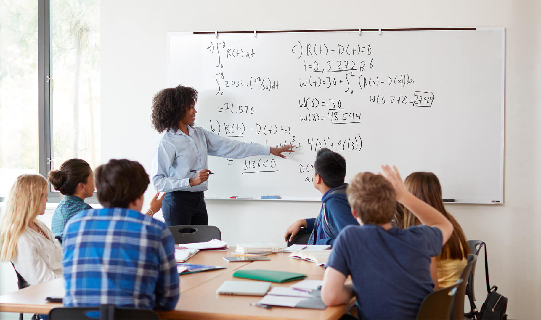 Team attending a presentation on a dry erase whiteboard