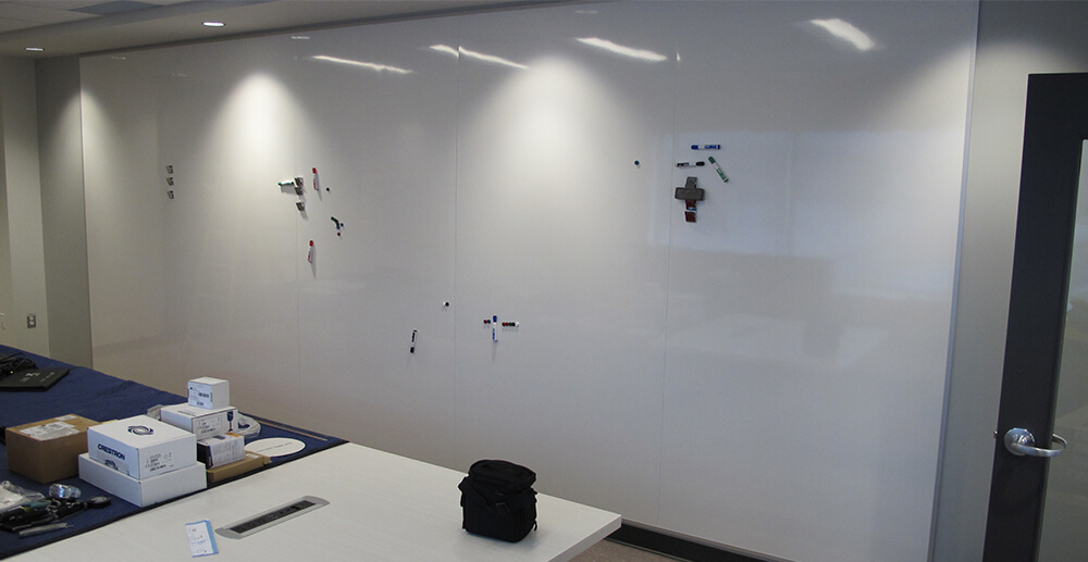 Wall-to-wall board with dry-erase surface